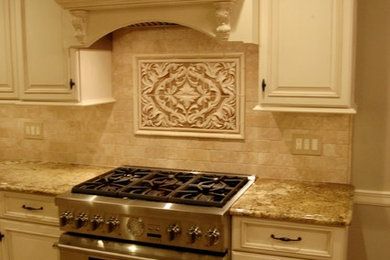 Example of a mid-sized classic l-shaped ceramic tile eat-in kitchen design in New York with an undermount sink, raised-panel cabinets, white cabinets, granite countertops, beige backsplash, ceramic backsplash, stainless steel appliances and no island