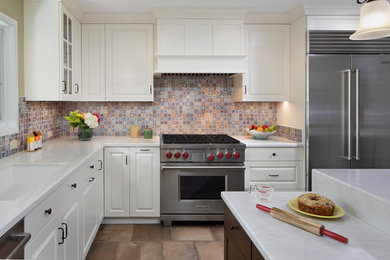 Example of a transitional l-shaped porcelain tile and brown floor eat-in kitchen design in San Francisco with an undermount sink, raised-panel cabinets, quartz countertops, multicolored backsplash, mosaic tile backsplash, stainless steel appliances, an island and white countertops