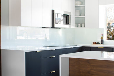 Small 1960s l-shaped porcelain tile and black floor open concept kitchen photo in Omaha with an undermount sink, flat-panel cabinets, gray cabinets, quartzite countertops, white backsplash, glass sheet backsplash, paneled appliances, a peninsula and white countertops