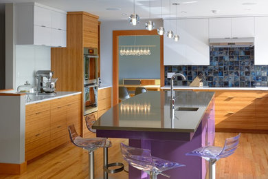 Inspiration for a contemporary l-shaped eat-in kitchen remodel in Seattle with an undermount sink, quartz countertops, blue backsplash, ceramic backsplash and stainless steel appliances