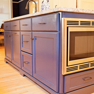 Photo of a mediterranean kitchen in Other with an undermount sink, flat-panel cabinets, beige cabinets, granite benchtops, multiple islands and beige benchtop.