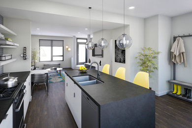 Example of a mid-sized minimalist single-wall medium tone wood floor and brown floor open concept kitchen design in Richmond with a double-bowl sink, flat-panel cabinets, white cabinets, concrete countertops, gray backsplash, ceramic backsplash, stainless steel appliances and an island