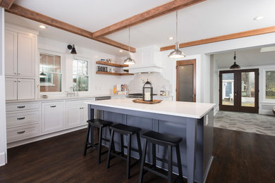 Example of an u-shaped dark wood floor eat-in kitchen design in Indianapolis with a double-bowl sink, shaker cabinets, white cabinets, marble countertops, white backsplash, wood backsplash, stainless steel appliances and an island