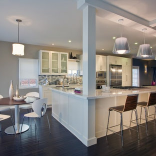 Large contemporary eat-in kitchen designs - Inspiration for a large contemporary dark wood floor eat-in kitchen remodel in Santa Barbara with stainless steel appliances, white cabinets, multicolored backsplash, matchstick tile backsplash and an island