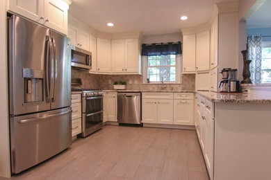 Enclosed kitchen - small transitional u-shaped gray floor enclosed kitchen idea in New York with shaker cabinets, white cabinets, quartzite countertops, a peninsula, gray countertops, gray backsplash, stainless steel appliances and a double-bowl sink