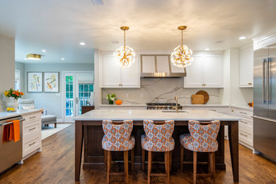 Inspiration for a large transitional u-shaped dark wood floor kitchen remodel in Other with a farmhouse sink, beaded inset cabinets, white cabinets, quartz countertops, gray backsplash, stainless steel appliances, an island and yellow countertops