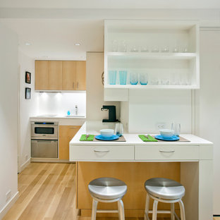 Small scandinavian open concept kitchen photos - Open concept kitchen - small scandinavian l-shaped light wood floor and brown floor open concept kitchen idea in New York with open cabinets, stainless steel appliances, an undermount sink, white cabinets, solid surface countertops, white backsplash and no island