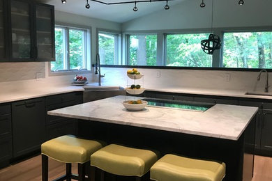 Mid-sized 1960s l-shaped light wood floor and beige floor eat-in kitchen photo in Boston with a farmhouse sink, shaker cabinets, gray cabinets, marble countertops, white backsplash, ceramic backsplash, paneled appliances, an island and white countertops