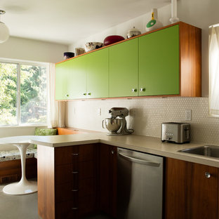 This is an example of a small midcentury u-shaped separate kitchen in Vancouver with a double-bowl sink, flat-panel cabinets, green cabinets, laminate benchtops, white splashback, ceramic splashback, stainless steel appliances, linoleum floors, no island and grey floor.