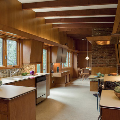 Mid-sized mid-century modern u-shaped carpeted enclosed kitchen photo in Portland with mosaic tile backsplash, a drop-in sink, flat-panel cabinets, medium tone wood cabinets, laminate countertops, multicolored backsplash, stainless steel appliances and no island