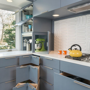 Mid-century modern kitchen designs - Example of a 1960s u-shaped dark wood floor kitchen design in Boston with an undermount sink, flat-panel cabinets, gray cabinets, quartzite countertops, white backsplash, ceramic backsplash and stainless steel appliances