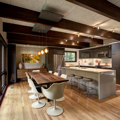 Mid-sized 1960s l-shaped light wood floor eat-in kitchen photo in Indianapolis with an undermount sink, flat-panel cabinets, gray cabinets, quartz countertops, white backsplash, ceramic backsplash and stainless steel appliances