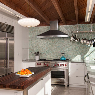 This is an example of a midcentury kitchen in San Diego with an undermount sink, flat-panel cabinets, white cabinets, multi-coloured splashback, mosaic tile splashback, stainless steel appliances, with island, marble benchtops and marble floors.