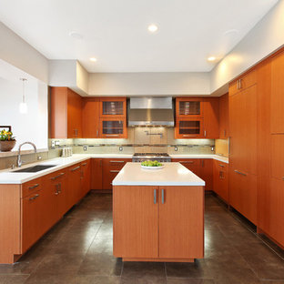 This is an example of a mid-sized midcentury u-shaped eat-in kitchen in Chicago with an undermount sink, flat-panel cabinets, light wood cabinets, quartz benchtops, beige splashback, porcelain splashback, stainless steel appliances, porcelain floors and with island.