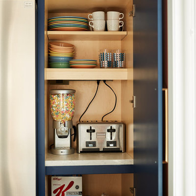 Inspiration for a mid-sized 1960s u-shaped cement tile floor and gray floor enclosed kitchen remodel in Minneapolis with an undermount sink, flat-panel cabinets, blue cabinets, quartz countertops, white backsplash, cement tile backsplash, stainless steel appliances, no island and black countertops