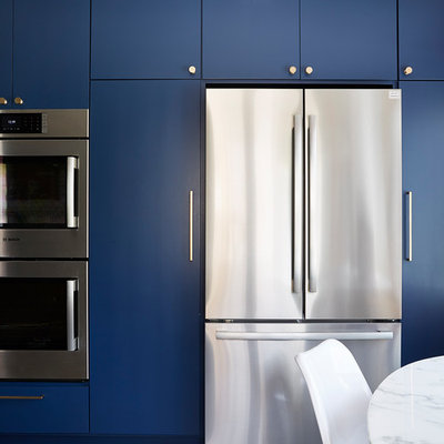 Enclosed kitchen - mid-sized 1960s u-shaped cement tile floor and gray floor enclosed kitchen idea in Minneapolis with an undermount sink, flat-panel cabinets, blue cabinets, quartz countertops, white backsplash, cement tile backsplash, stainless steel appliances, no island and black countertops