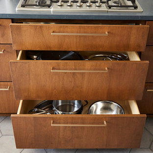 Inspiration for a mid-sized midcentury u-shaped separate kitchen in Minneapolis with an undermount sink, flat-panel cabinets, medium wood cabinets, quartz benchtops, white splashback, cement tile splashback, stainless steel appliances, cement tiles, no island, grey floor and black benchtop.