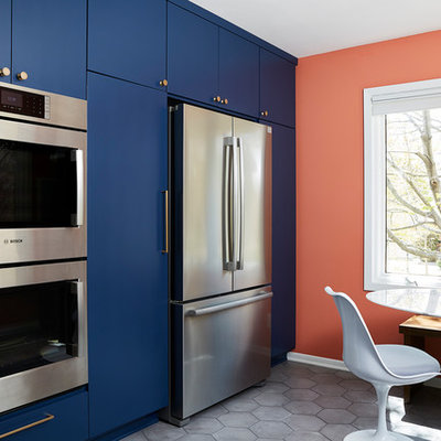 Mid-sized 1960s u-shaped cement tile floor and gray floor enclosed kitchen photo in Minneapolis with an undermount sink, flat-panel cabinets, quartz countertops, white backsplash, cement tile backsplash, stainless steel appliances, no island, black countertops and blue cabinets