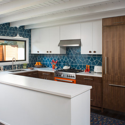 Inspiration for a mid-sized 1960s u-shaped dark wood floor and brown floor eat-in kitchen remodel in Los Angeles with an undermount sink, flat-panel cabinets, medium tone wood cabinets, quartz countertops, blue backsplash, ceramic backsplash, colored appliances, a peninsula and white countertops