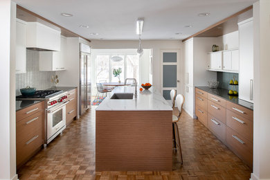 Inspiration for a mid-sized 1960s galley brown floor and medium tone wood floor eat-in kitchen remodel in Minneapolis with an undermount sink, flat-panel cabinets, quartz countertops, gray backsplash, stainless steel appliances, an island, medium tone wood cabinets and black countertops