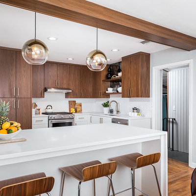 Inspiration for a small 1960s l-shaped brown floor and medium tone wood floor eat-in kitchen remodel in Miami with flat-panel cabinets, quartz countertops, white backsplash, mosaic tile backsplash, stainless steel appliances, a peninsula, an undermount sink, medium tone wood cabinets and white countertops