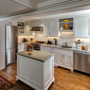 Inspiration for a small country u-shaped medium tone wood floor kitchen remodel in New York with an undermount sink, recessed-panel cabinets, white cabinets, white backsplash, subway tile backsplash, stainless steel appliances and an island