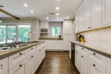 Large 1960s galley medium tone wood floor kitchen pantry photo in Dallas with an undermount sink, shaker cabinets, white cabinets, quartzite countertops, gray backsplash, stone tile backsplash and a peninsula