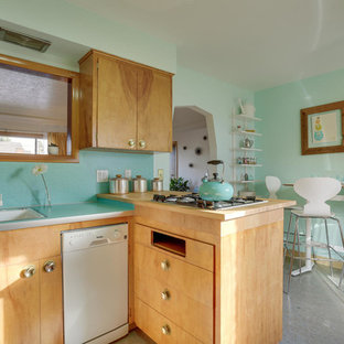 Inspiration for a mid-sized midcentury u-shaped eat-in kitchen in Portland with a drop-in sink, flat-panel cabinets, light wood cabinets, laminate benchtops, blue splashback, white appliances, linoleum floors, a peninsula and turquoise floor.