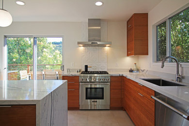 This is an example of a medium sized midcentury open plan kitchen in San Francisco with a submerged sink, flat-panel cabinets, medium wood cabinets, quartz worktops, white splashback, ceramic splashback, stainless steel appliances, ceramic flooring, an island and beige floors.