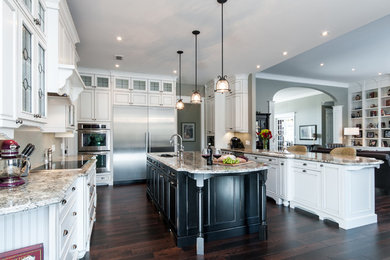 Eat-in kitchen - huge traditional u-shaped dark wood floor eat-in kitchen idea in Toronto with an undermount sink, beaded inset cabinets, white cabinets, granite countertops, stainless steel appliances and an island