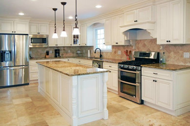 Photo of a large contemporary l-shaped enclosed kitchen in New York with a submerged sink, raised-panel cabinets, beige cabinets, granite worktops, stone tiled splashback, stainless steel appliances, porcelain flooring and an island.