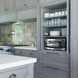 Photo of an expansive arts and crafts galley eat-in kitchen in Omaha with beaded inset cabinets, grey cabinets, blue splashback, ceramic splashback, panelled appliances and multiple islands.