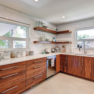 Example of a mid-sized minimalist l-shaped porcelain tile enclosed kitchen design in San Luis Obispo with an undermount sink, flat-panel cabinets, medium tone wood cabinets, quartz countertops, white backsplash, porcelain backsplash and stainless steel appliances