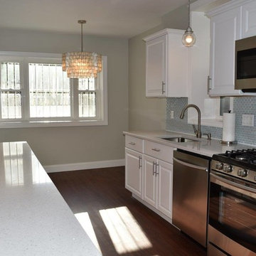 Milk Glass Tile Backsplash In Galley Kitchen