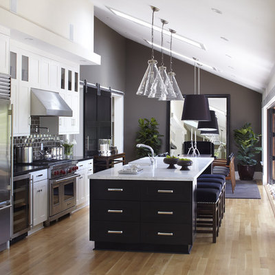 Inspiration for a huge transitional single-wall light wood floor, beige floor and vaulted ceiling eat-in kitchen remodel in San Francisco with stainless steel appliances, subway tile backsplash, brown backsplash, shaker cabinets, marble countertops, an undermount sink, white countertops and an island