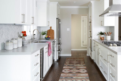 Inspiration for a mid-sized transitional galley medium tone wood floor and brown floor eat-in kitchen remodel in San Francisco with a single-bowl sink, shaker cabinets, yellow cabinets, quartzite countertops, white backsplash, mosaic tile backsplash, stainless steel appliances and an island