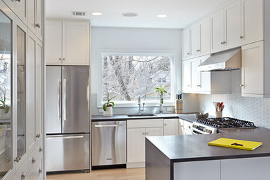 Kitchen - eclectic kitchen idea in New York with shaker cabinets and stainless steel appliances