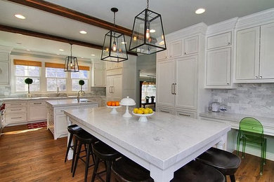 Photo of a large classic u-shaped kitchen/diner in Salt Lake City with a submerged sink, shaker cabinets, white cabinets, marble worktops, medium hardwood flooring, multiple islands, grey splashback, stone tiled splashback, integrated appliances, brown floors and white worktops.