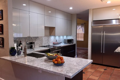 Eat-in kitchen - large modern u-shaped terra-cotta tile and brown floor eat-in kitchen idea in Miami with an undermount sink, flat-panel cabinets, white cabinets, quartz countertops, white backsplash, stone slab backsplash, stainless steel appliances, a peninsula and white countertops