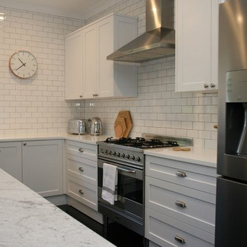 Grey hamptons style kitchen with corian benchtop