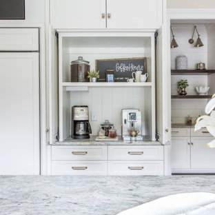 Large farmhouse eat-in kitchen designs - Inspiration for a large farmhouse dark wood floor eat-in kitchen remodel in Atlanta with shaker cabinets, white cabinets, white backsplash, wood backsplash, paneled appliances, an island and a farmhouse sink