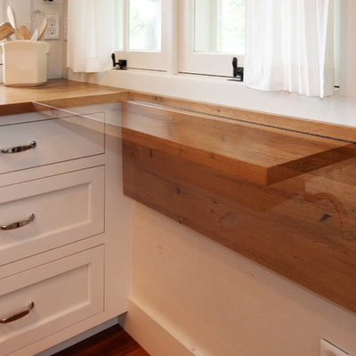 Kitchen - coastal galley kitchen idea in Other with shaker cabinets, white cabinets and wood countertops