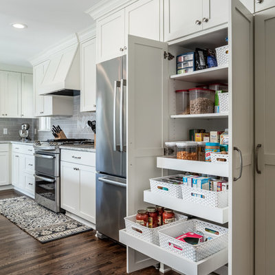 Kitchen pantry - mid-sized traditional dark wood floor kitchen pantry idea in Minneapolis with an undermount sink, shaker cabinets, white cabinets, granite countertops, gray backsplash, subway tile backsplash and stainless steel appliances