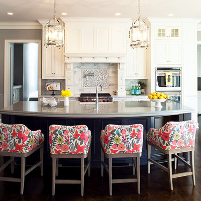 Example of a classic dark wood floor kitchen design in Minneapolis with white cabinets, stone tile backsplash, multicolored backsplash, recessed-panel cabinets, stainless steel appliances and an island