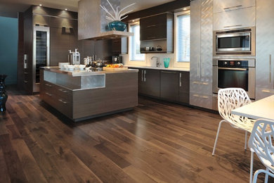 Large minimalist single-wall bamboo floor and brown floor kitchen photo in Toronto with flat-panel cabinets, brown cabinets, copper countertops, an island and white countertops