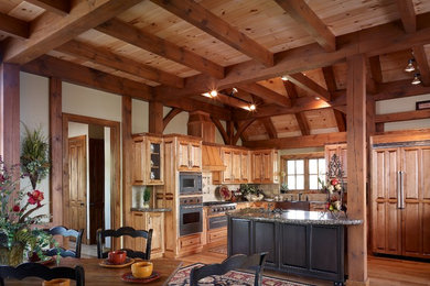 Eat-in kitchen - rustic light wood floor eat-in kitchen idea in Charlotte with raised-panel cabinets, light wood cabinets, granite countertops and an island