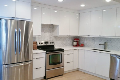Small minimalist l-shaped light wood floor eat-in kitchen photo in Calgary with an undermount sink, flat-panel cabinets, white cabinets, quartz countertops, white backsplash, stone tile backsplash and stainless steel appliances