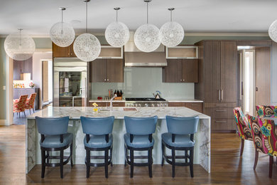 Example of a large transitional medium tone wood floor eat-in kitchen design in Kansas City with an undermount sink, flat-panel cabinets, marble countertops, glass sheet backsplash, stainless steel appliances, an island and dark wood cabinets