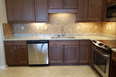 Mid-sized elegant l-shaped limestone floor and beige floor kitchen pantry photo in Miami with a drop-in sink, shaker cabinets, dark wood cabinets, quartzite countertops, orange backsplash, terra-cotta backsplash, stainless steel appliances, an island and multicolored countertops
