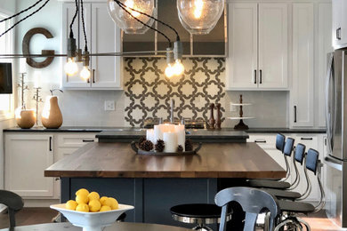Design ideas for a large rural u-shaped kitchen in Other with a belfast sink, flat-panel cabinets, white cabinets, wood worktops, white splashback, marble splashback, stainless steel appliances, medium hardwood flooring, an island, brown floors and brown worktops.